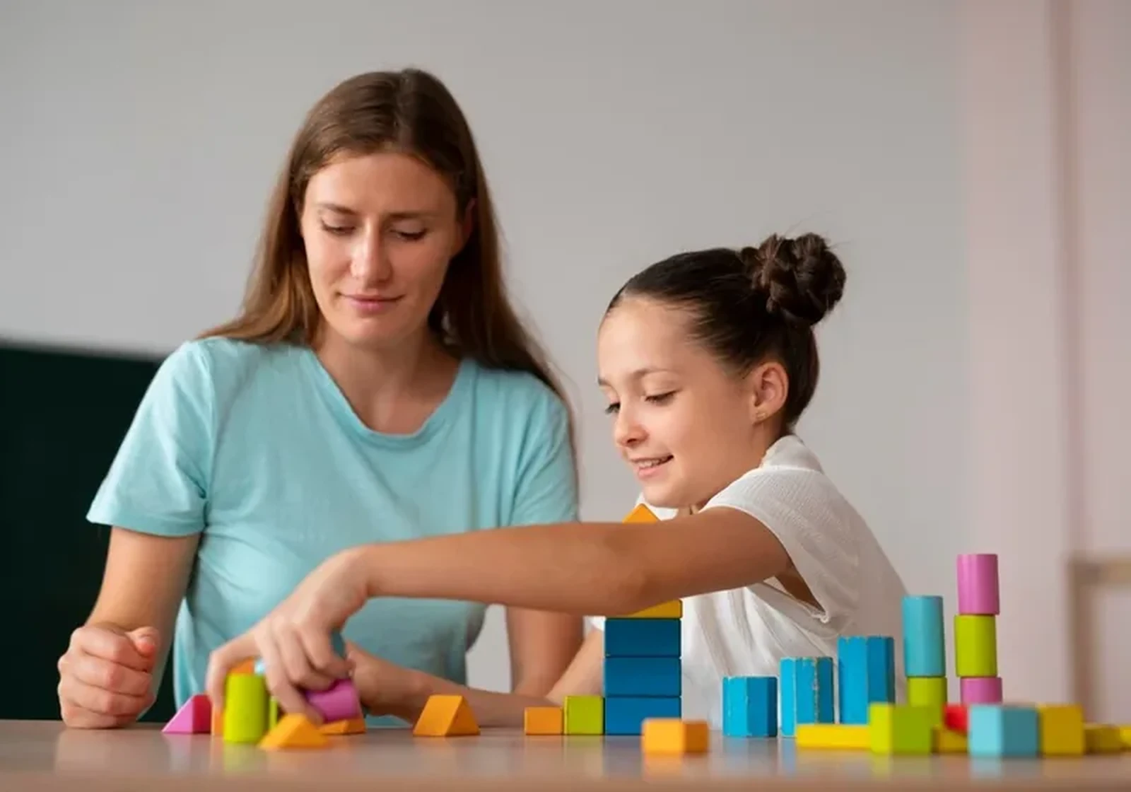 An occupational therapist working one-on-one with a child